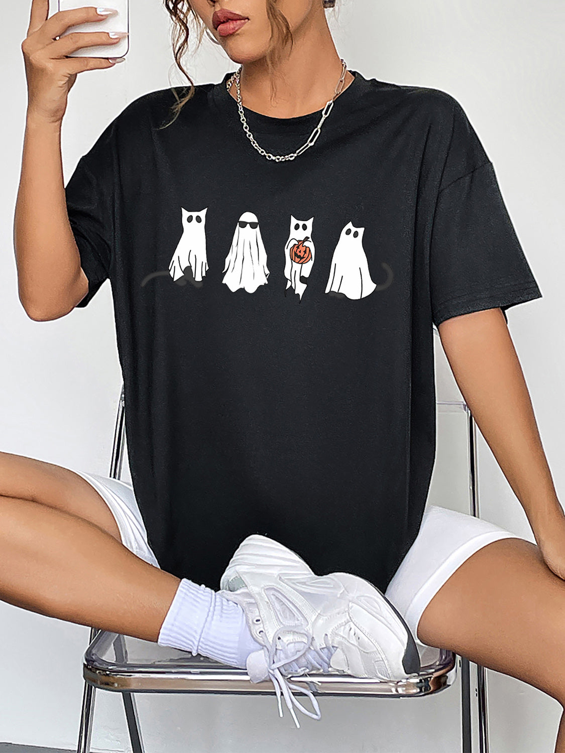 Black round neck short sleeve t-shirt with ghost graphic.