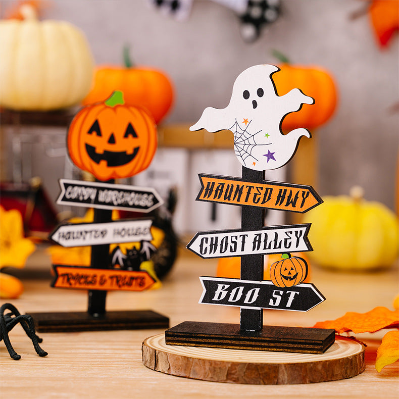 Two wooden Halloween-themed signpost ornaments with pumpkins and a ghost.