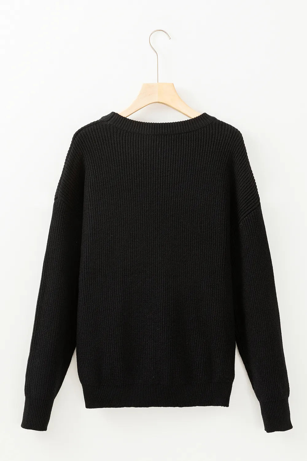 Black round neck long sleeve sweater on a hanger.