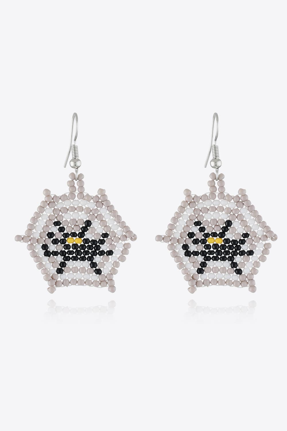 A pair of beaded Halloween-themed spiderweb earrings with a black and yellow spider.