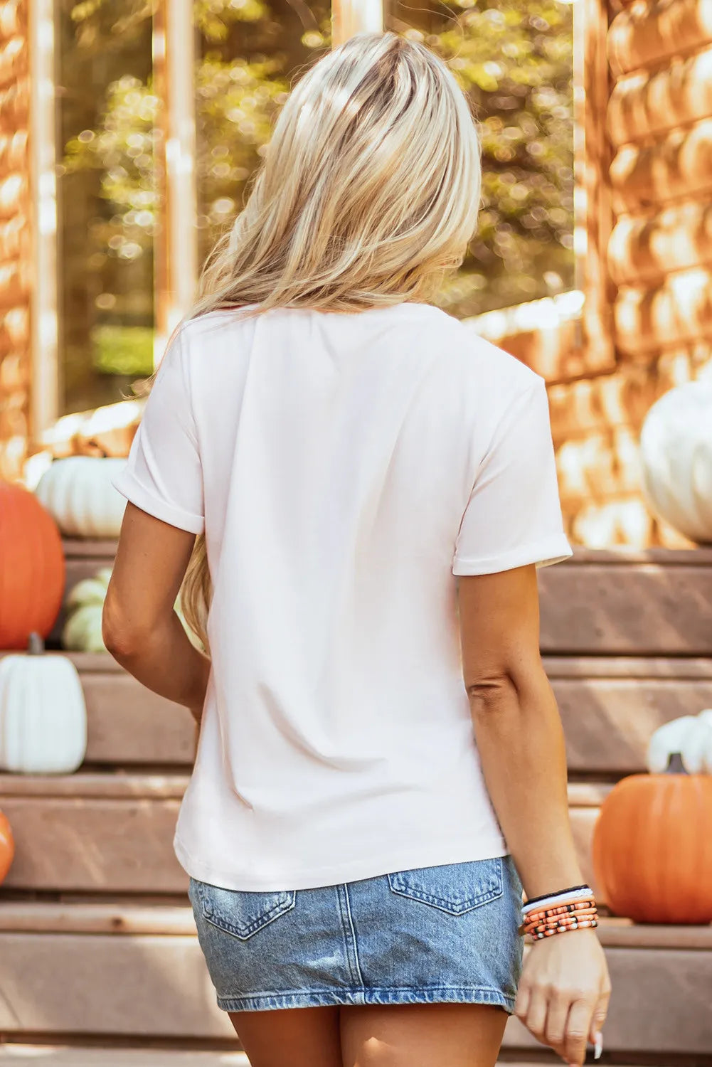 Pumpkin Round Neck Short Sleeve T-Shirt in light pink, worn with a denim skirt.