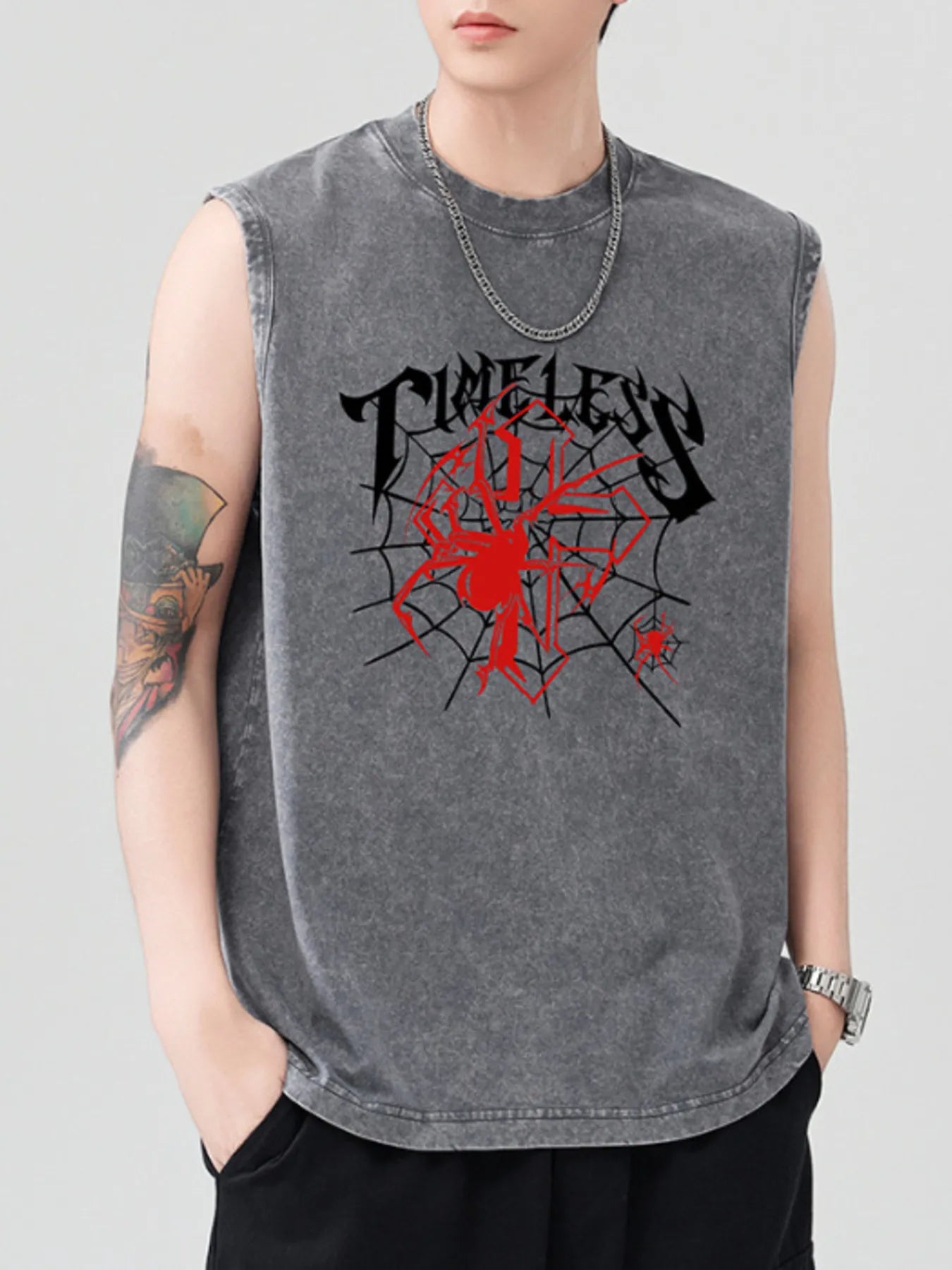 Men's gray spider graphic tank top with a silver chain necklace.