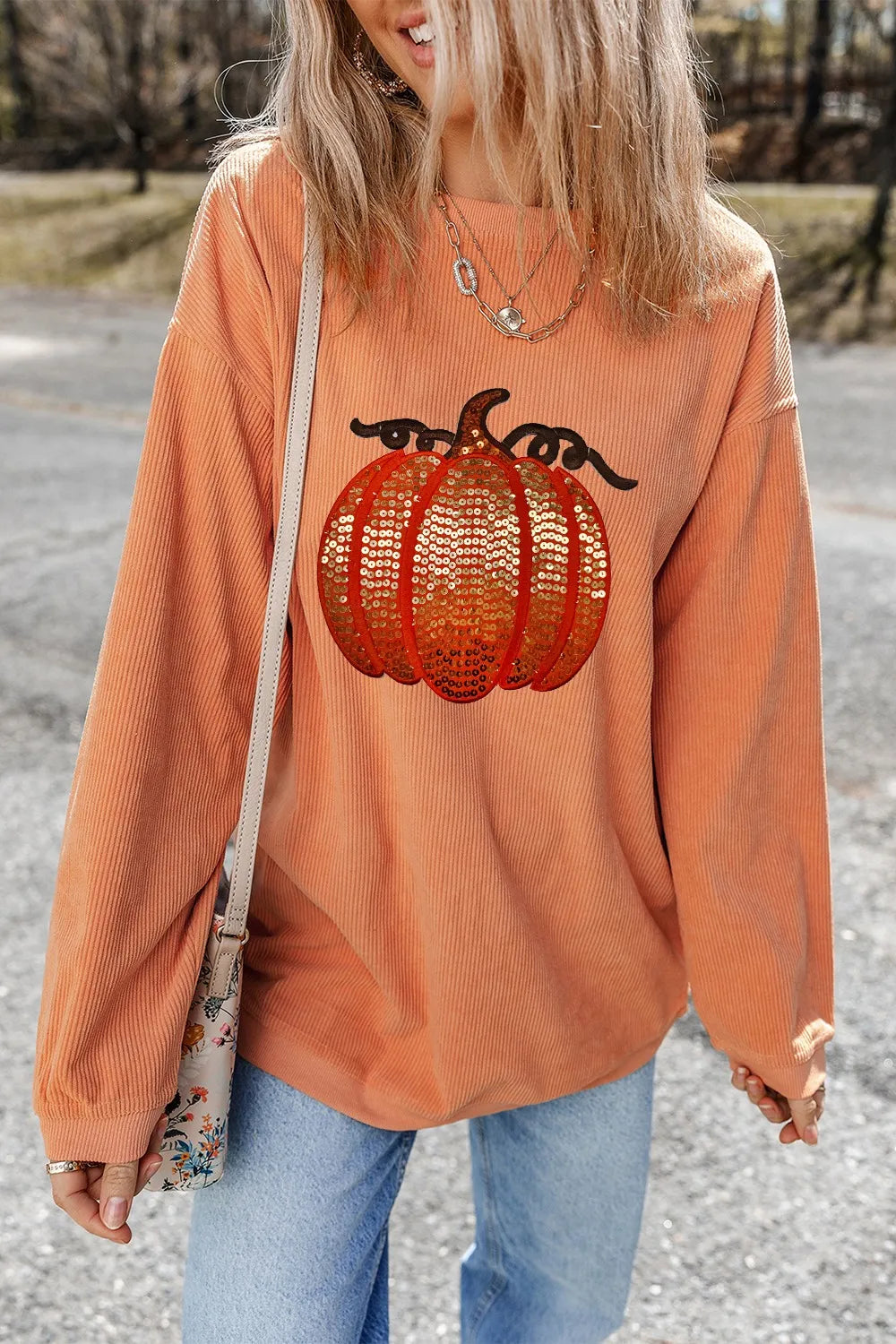 Sequin pumpkin round neck long sleeve sweatshirt.