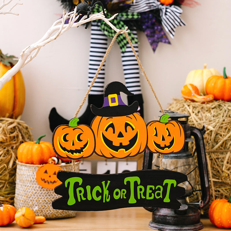 A Halloween "Trick or Treat" sign featuring three jack-o'-lanterns, one wearing a witch's hat.
