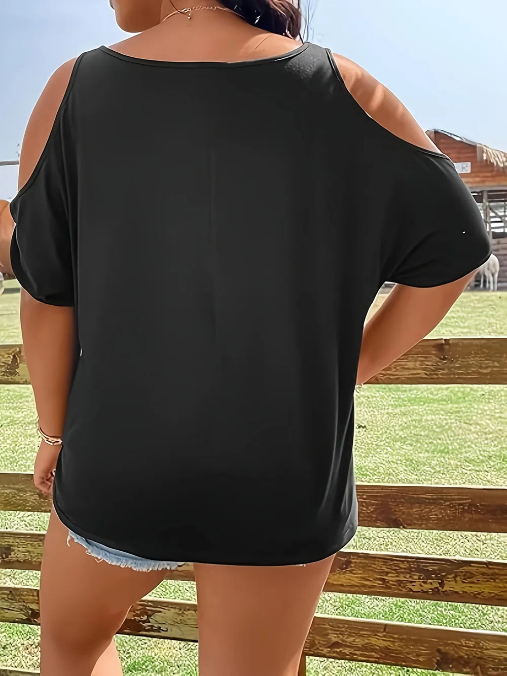 Plus size black cold shoulder t-shirt with a round neck.