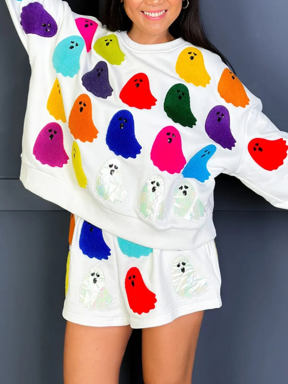 White long-sleeve top and shorts set with colorful and iridescent ghost prints.