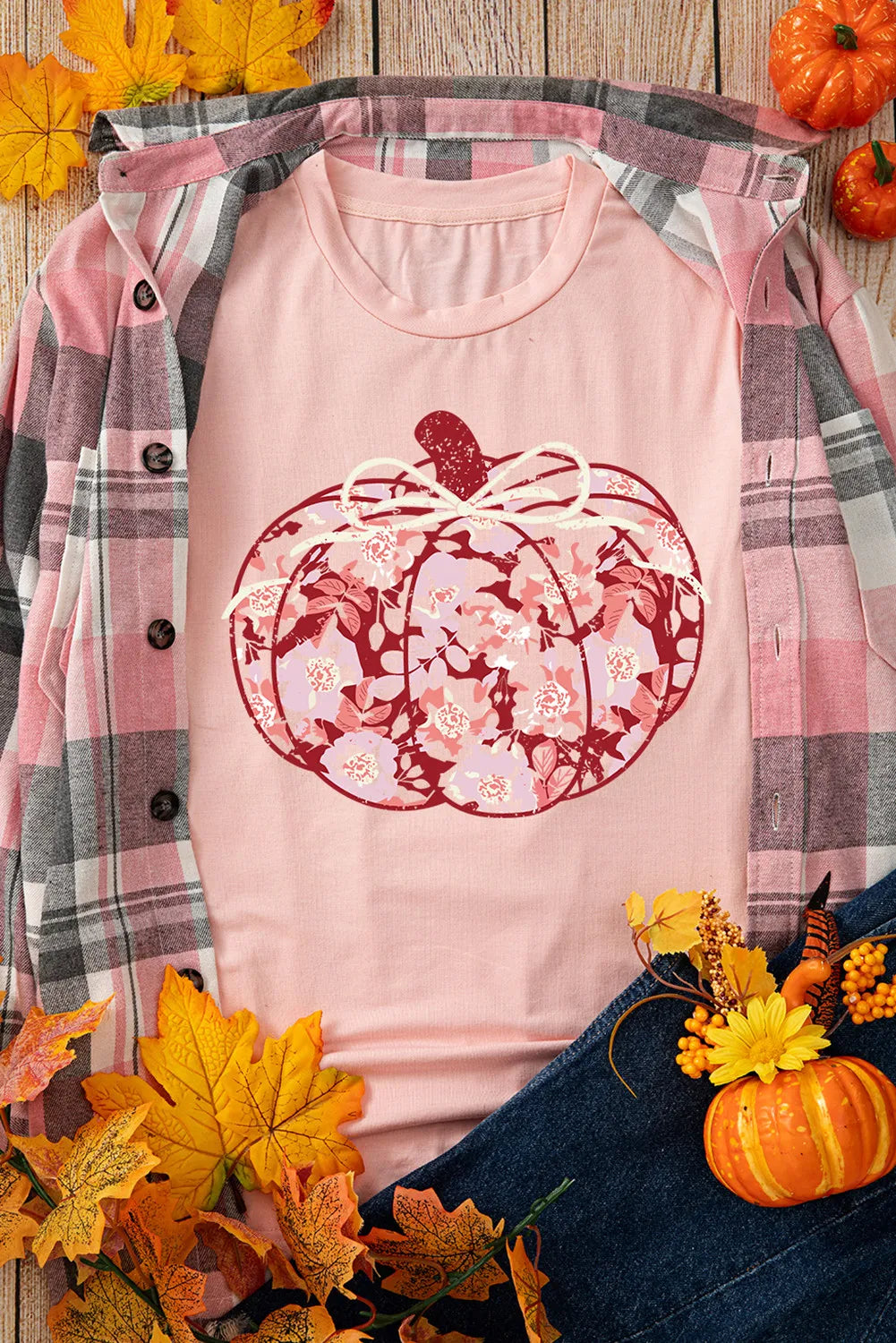 Pink long-sleeve t-shirt with a floral pumpkin graphic, paired with a plaid shirt.