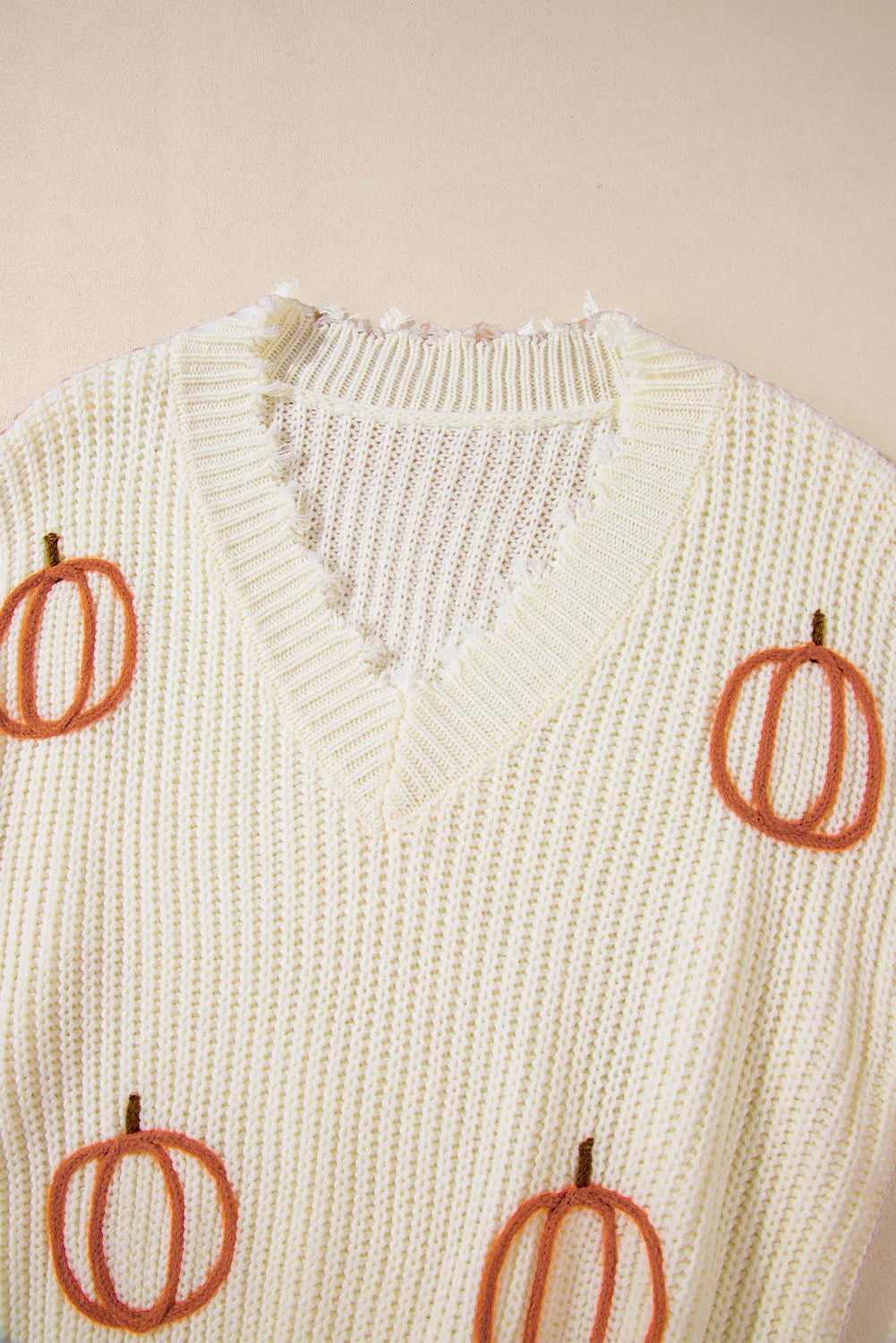 Raw hem pumpkin V-neck long sleeve sweater.