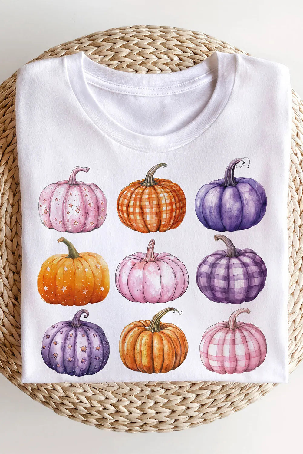 White long-sleeve sweatshirt with nine colorful pumpkin graphics.