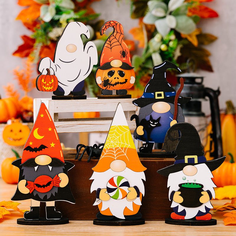 Assorted Halloween gnome and character ornaments are displayed on a wooden surface.