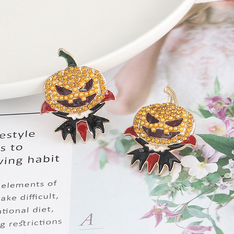 Two rhinestone alloy earrings shaped like demon pumpkins with red and black accents.