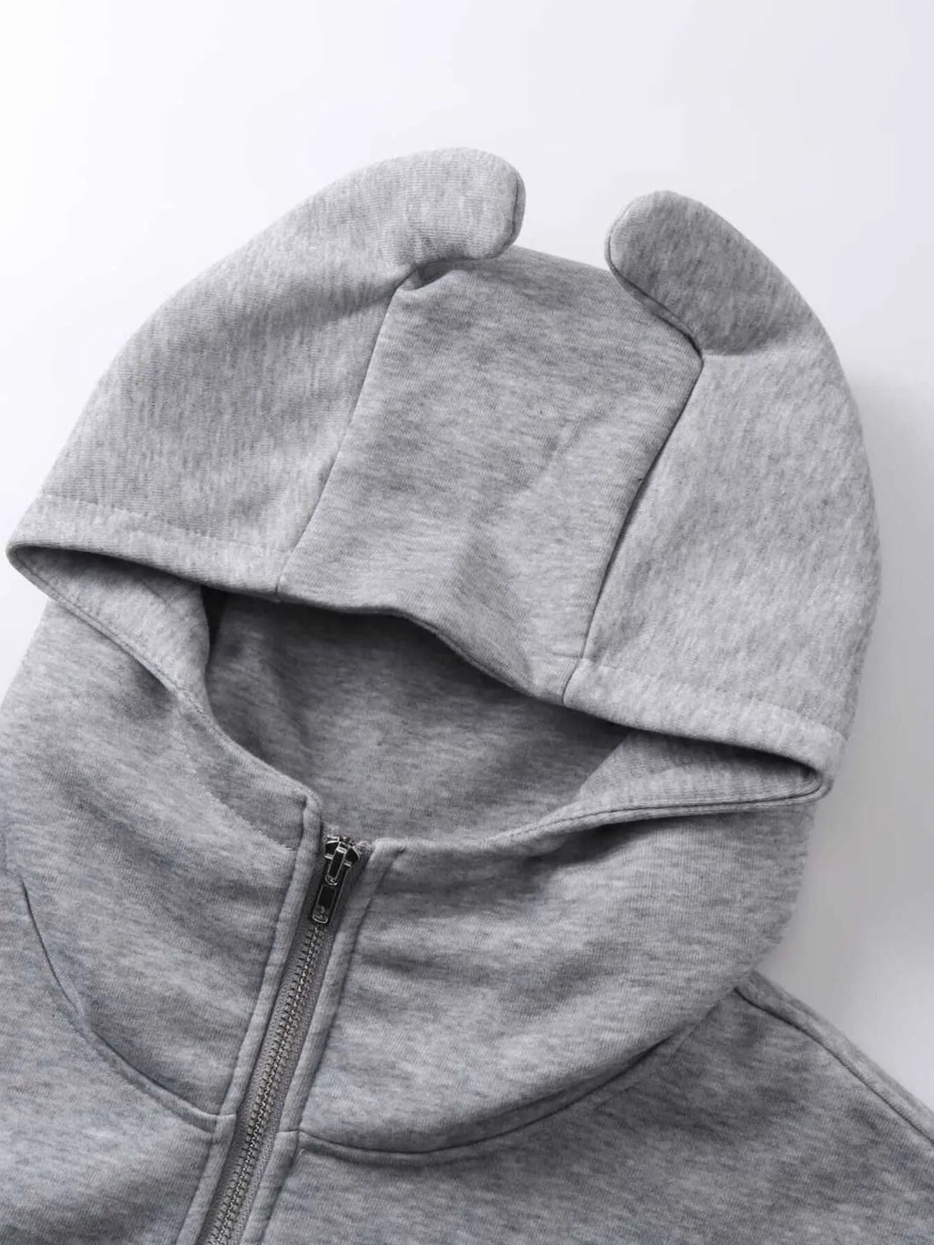 Gray zip-up hoodie with devil horns on the hood.