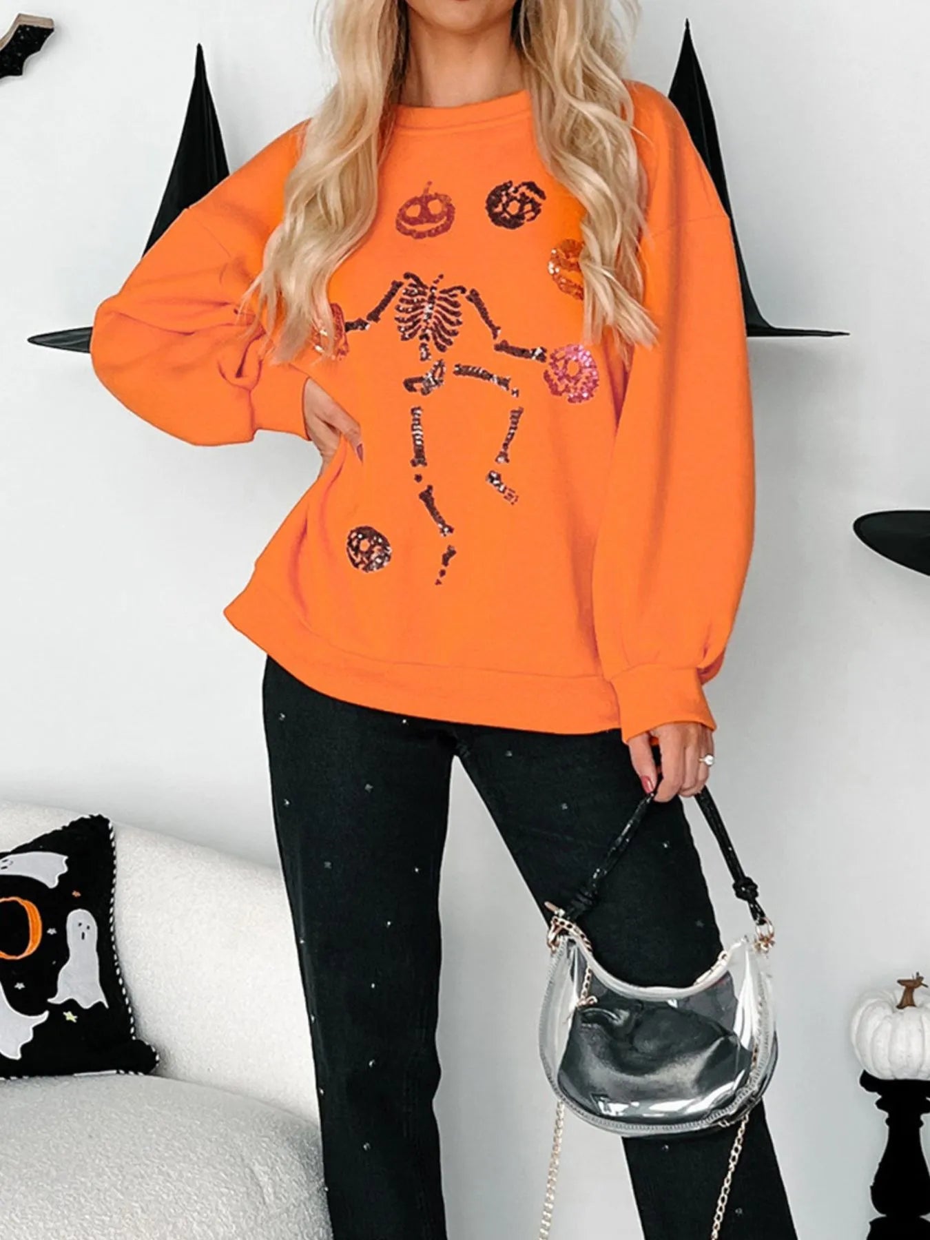 Halloween Skeleton Pumpkin Sweatshirt in orange with sequin details.