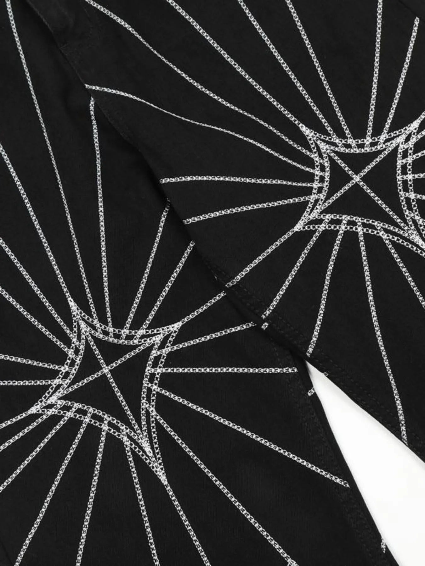 Black men's flared jeans with white spider web embroidery.