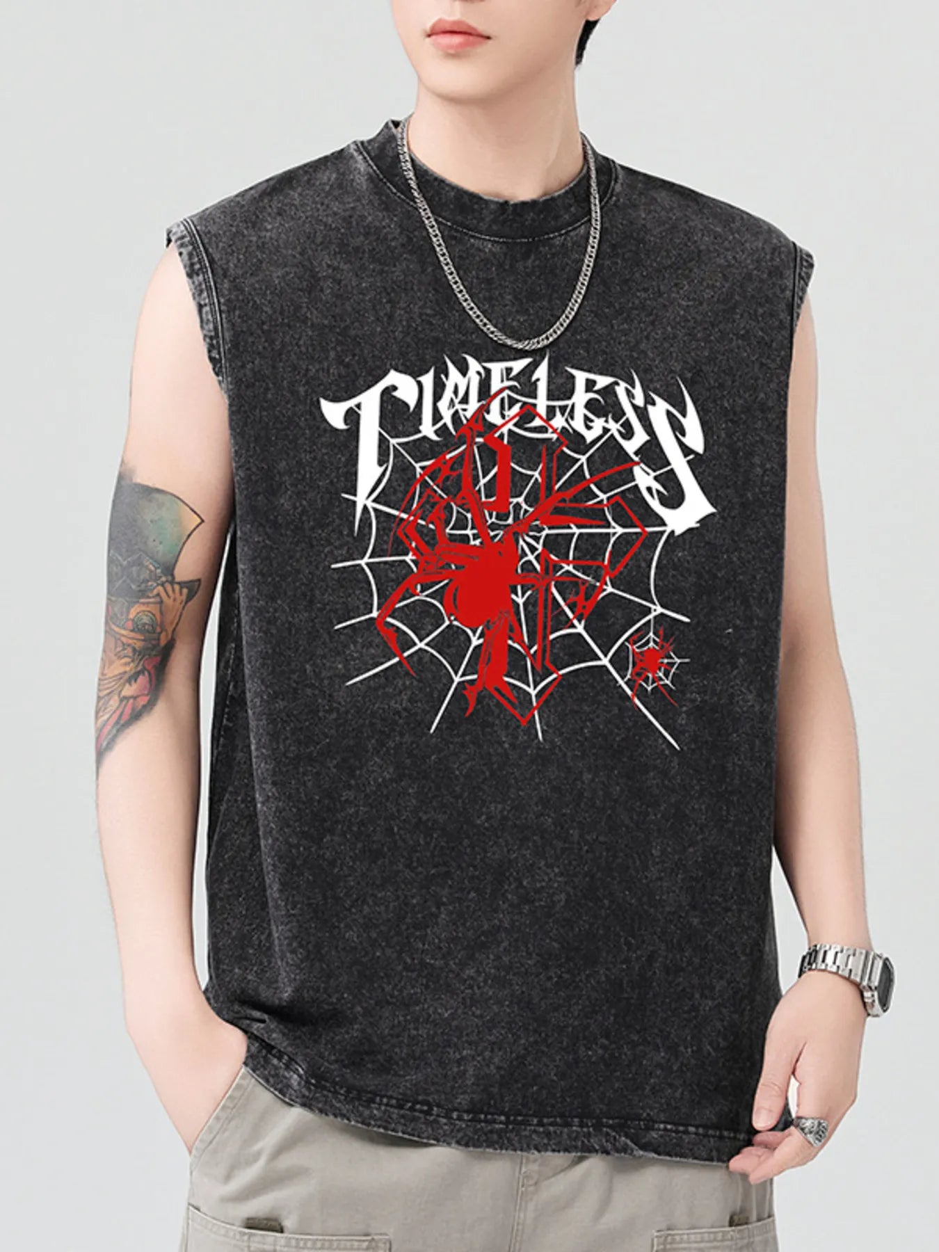Men's black spider graphic tank top with a silver chain necklace.