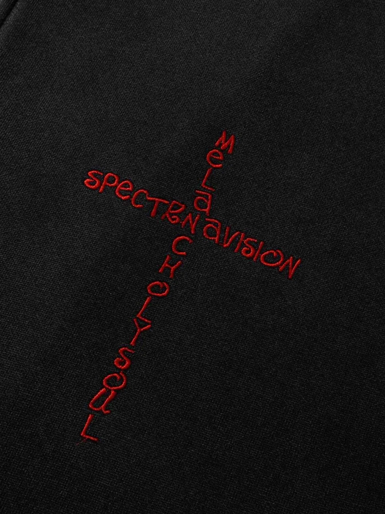 Black hoodie with red embroidered text forming a cross shape.