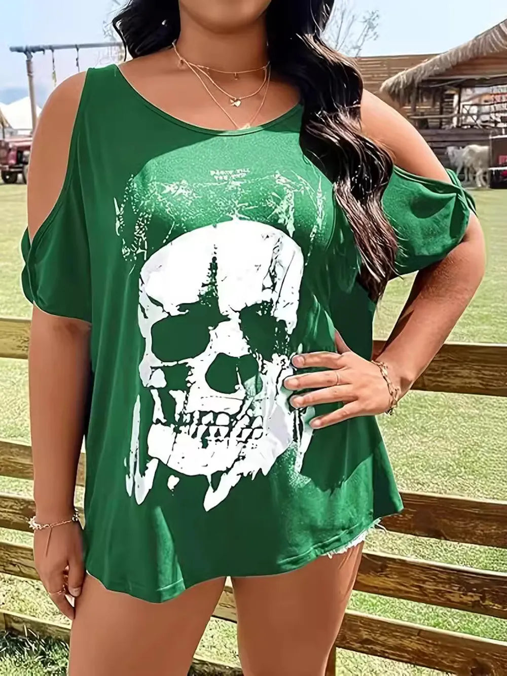 Plus size green cold shoulder t-shirt with a white skeleton graphic.