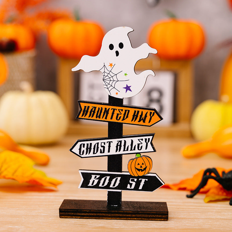 A wooden Halloween signpost with a ghost on top and three directional arrows.