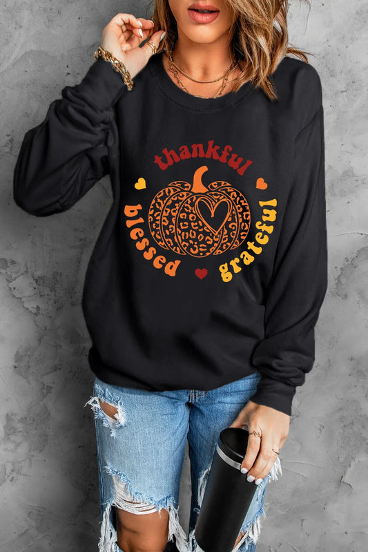 Black long sleeve sweatshirt with a pumpkin graphic and "thankful blessed grateful" text.