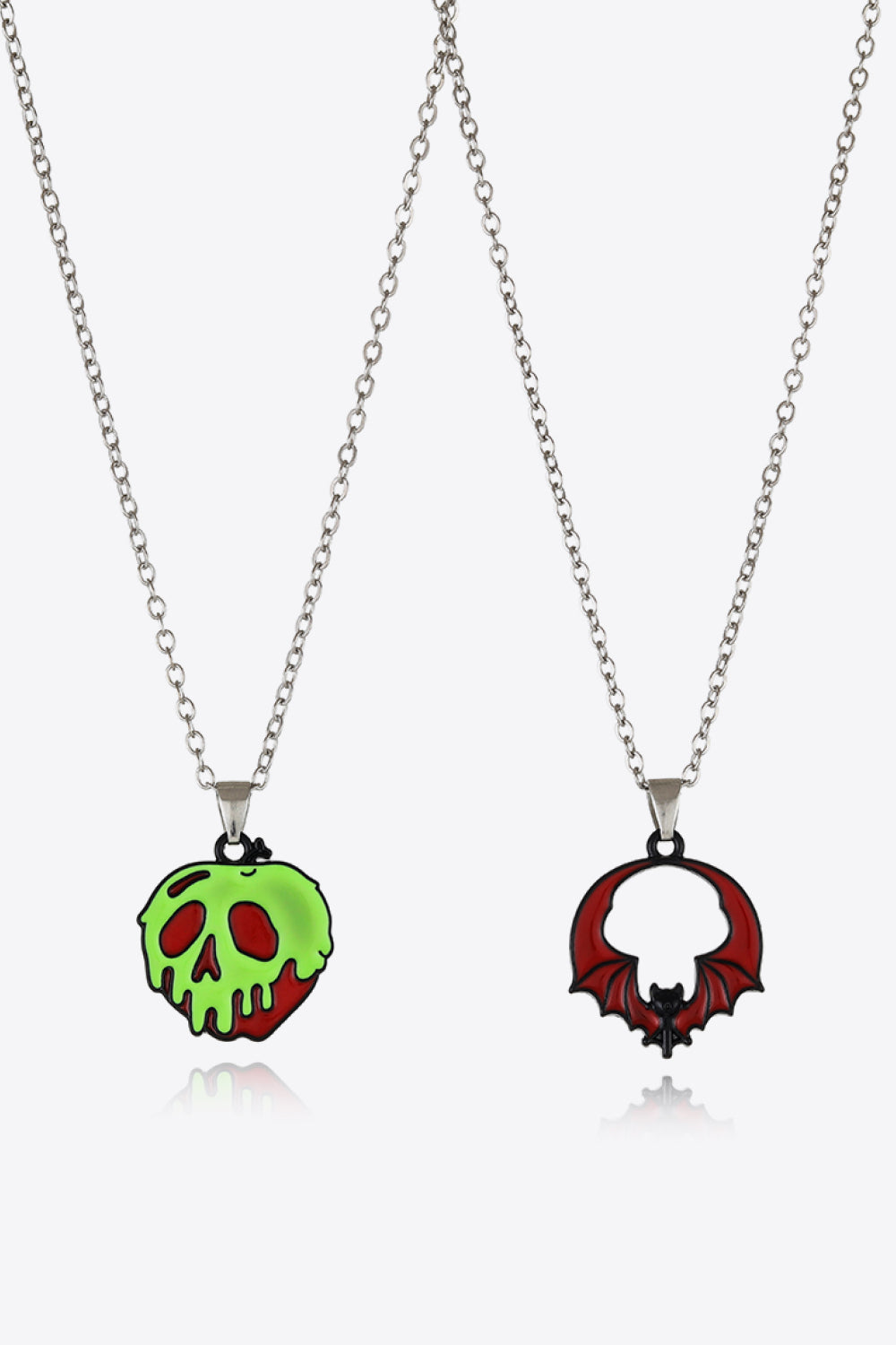 Two-piece Halloween theme necklace set with a green poison apple and a red bat pendant.