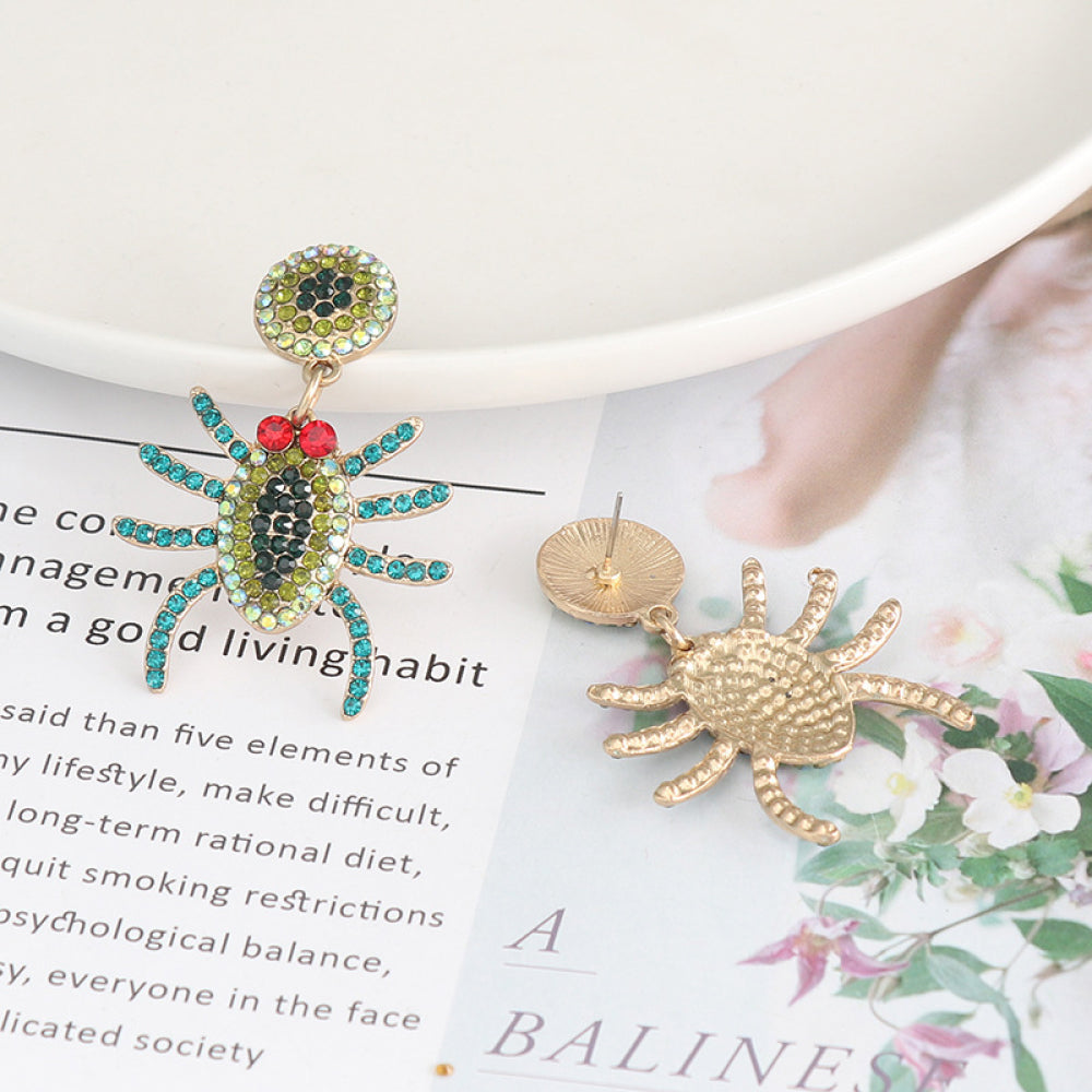 Spider rhinestone alloy earrings, one with colorful gems and the other showing the gold back.