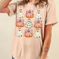 A woman wears a Halloween graphic t-shirt with ghosts and pumpkins with pink bows.