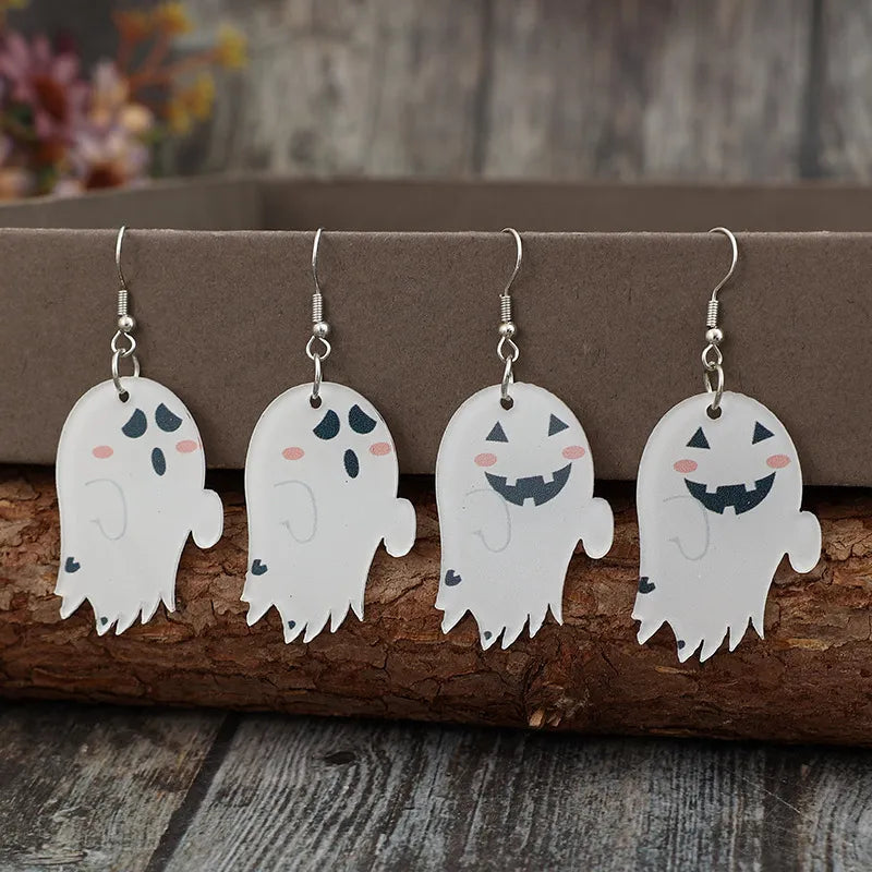 A pair of ghost dangle earrings with two different facial expressions.