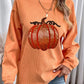 An orange ribbed sweatshirt with a sequined pumpkin design.