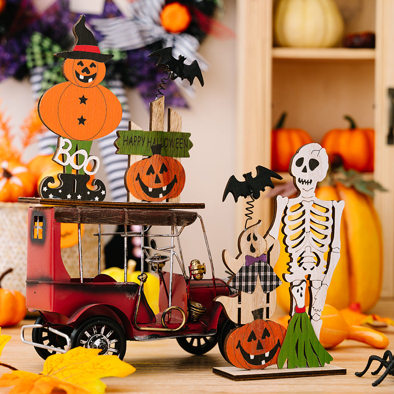 Two wooden Halloween decor ornaments featuring a pumpkin scarecrow and a skeleton with a ghost.