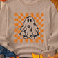 A beige long-sleeve sweatshirt with a ghost and checkerboard graphic.