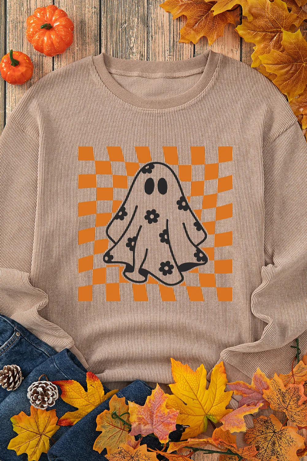 A beige long-sleeve sweatshirt with a ghost and checkerboard graphic.