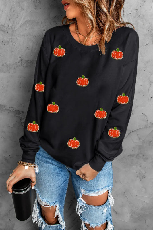 Black long-sleeve sweatshirt with scattered orange pumpkin appliques.