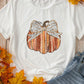 White short-sleeve t-shirt with a pumpkin graphic and leopard print bow.