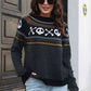 A woman wears a black ghost pattern round neck long sleeve sweater and light blue jeans.