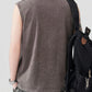 Men's Spider Round Neck Tank in a washed dark gray, worn with a black backpack.