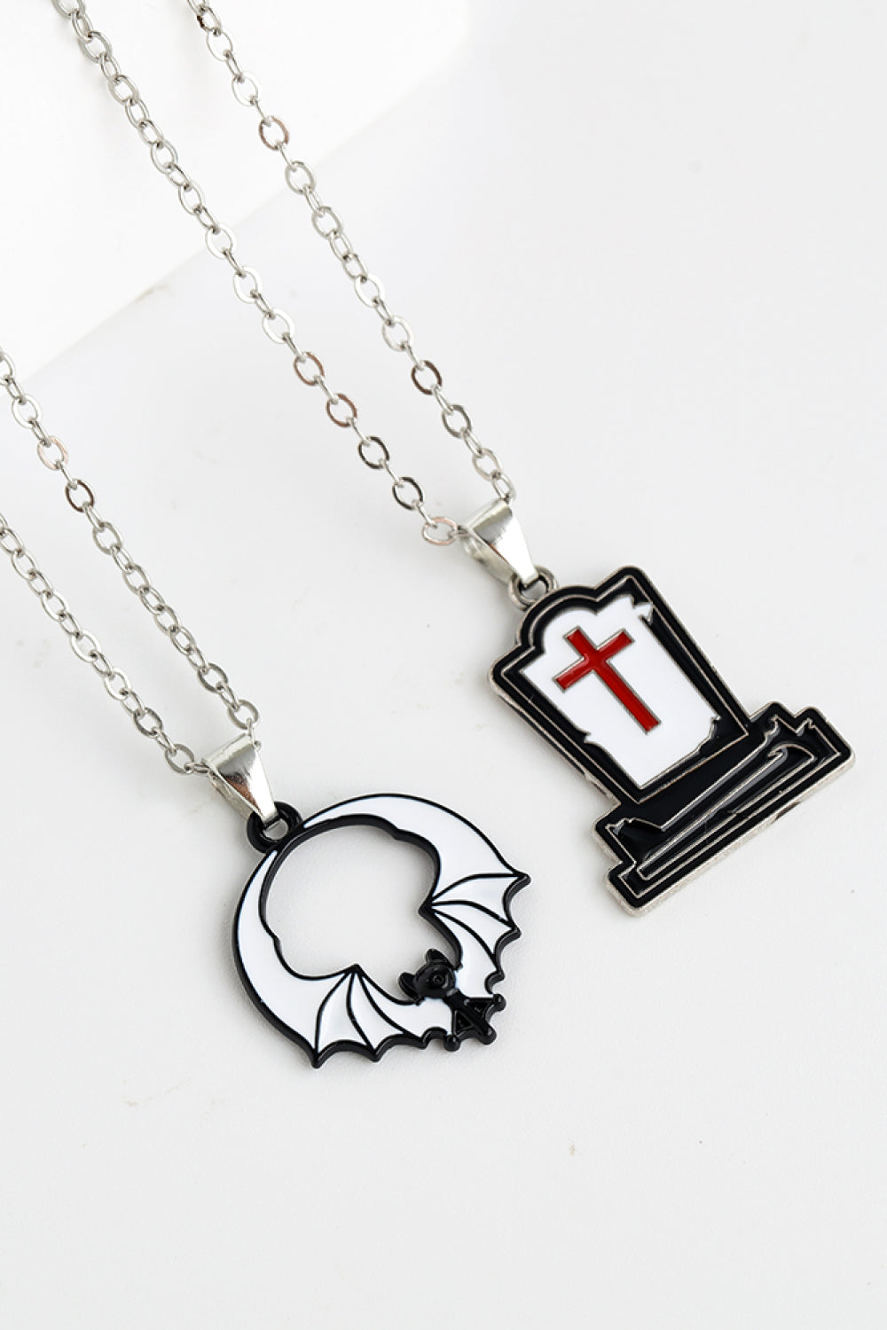 Two-piece Halloween theme necklace set with a bat and a tombstone pendant.