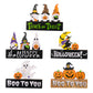 Five assorted Halloween-themed wooden ornaments are displayed.