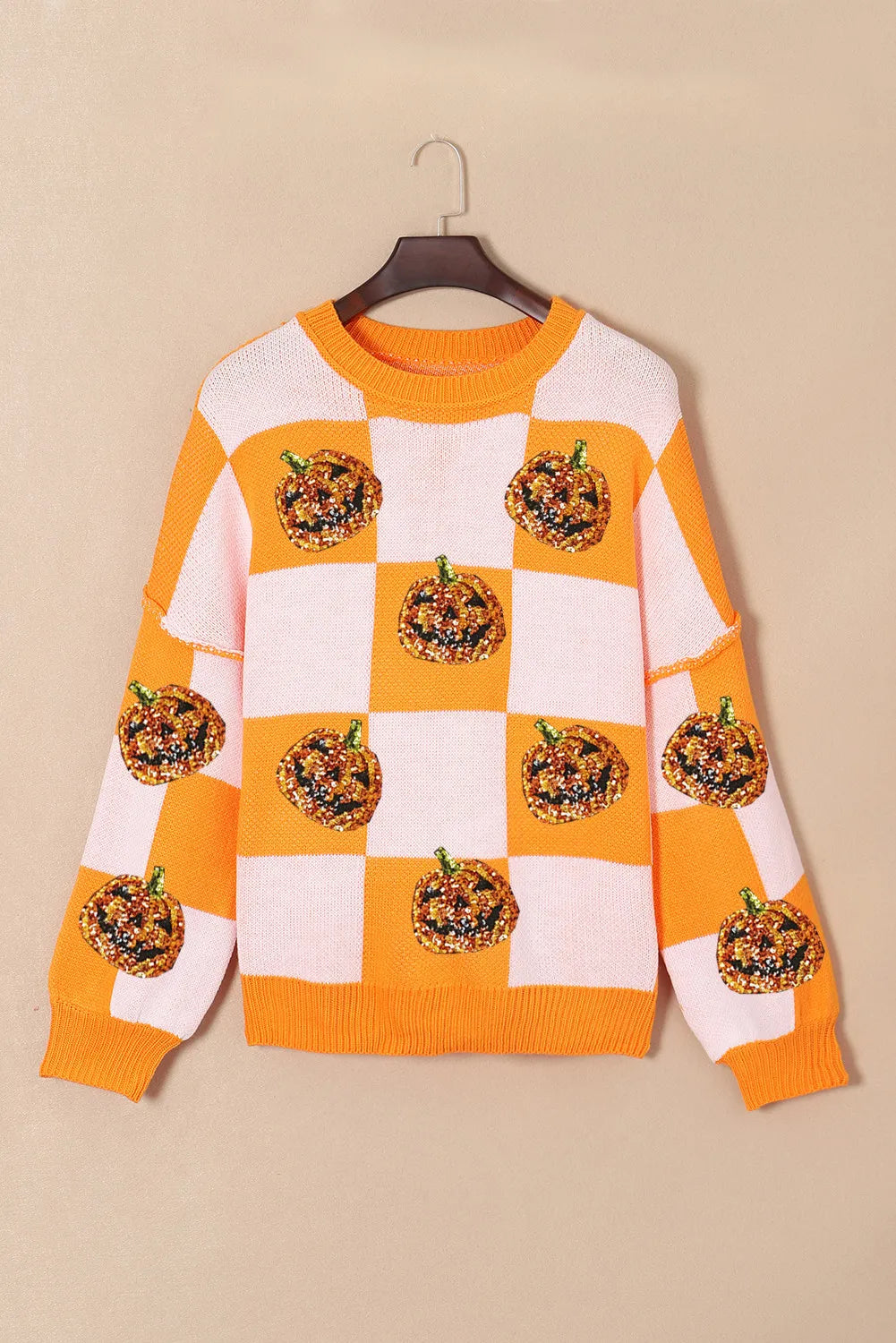 Pumpkin checkered round neck long sleeve sweater with sequin pumpkins.