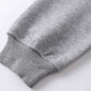 Close-up of a gray hoodie sleeve with a ribbed cuff.