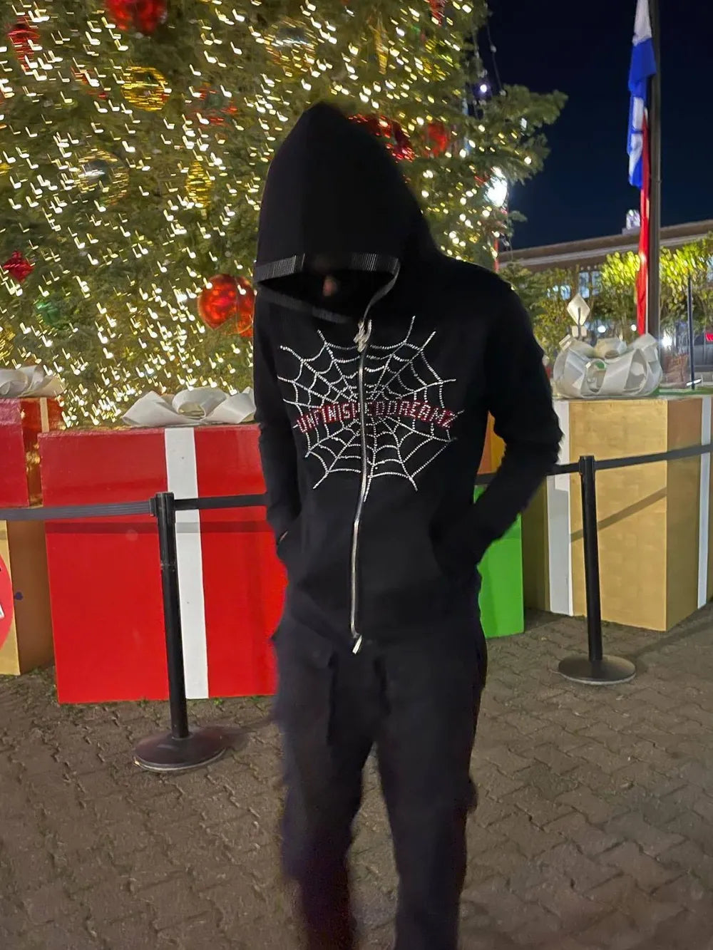 Men's black zip-up hoodie with a rhinestone spider web design.