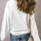Pumpkin Graphic Long Sleeve Sweatshirt in white, worn with blue jeans.
