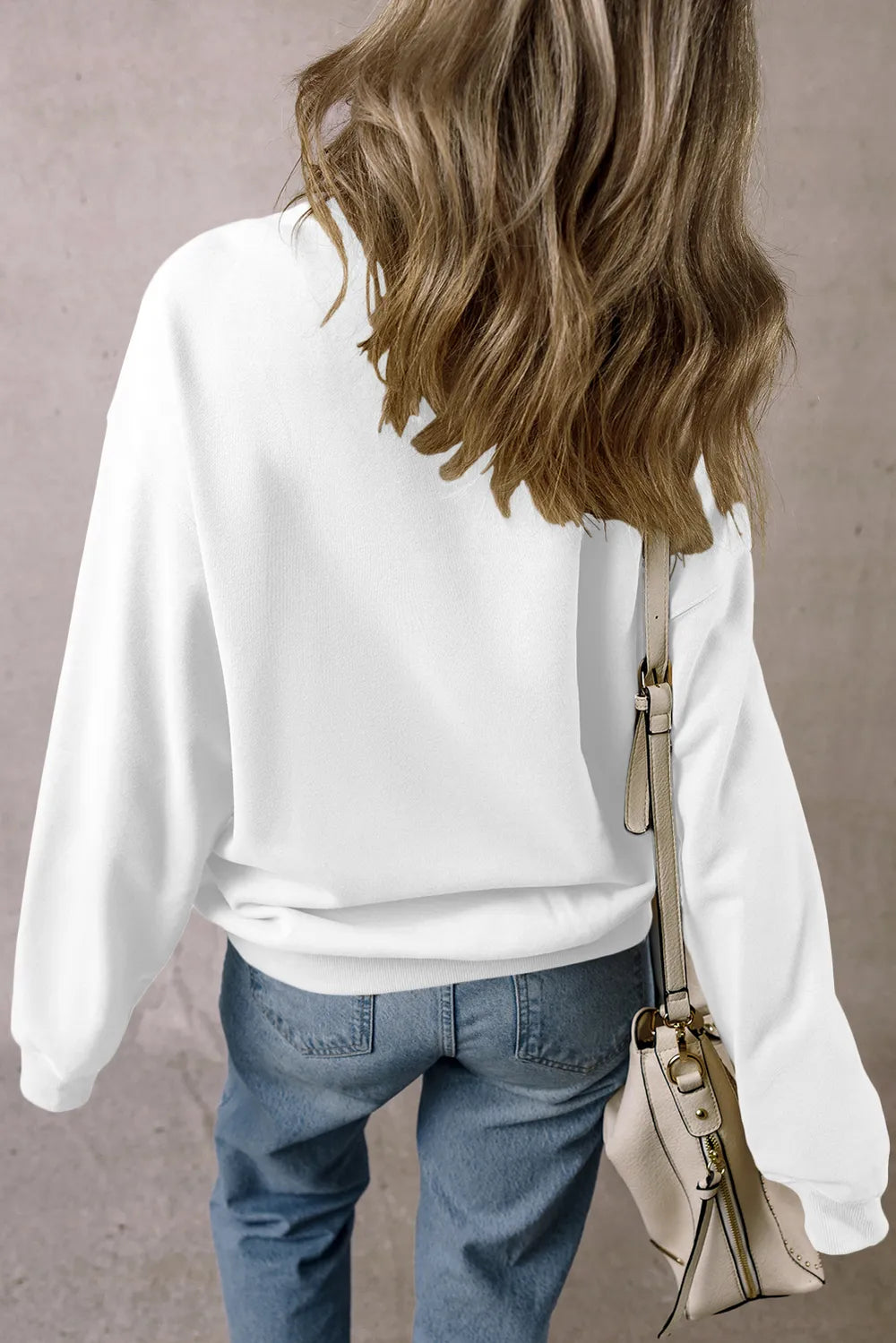 Pumpkin Graphic Long Sleeve Sweatshirt in white, worn with blue jeans.