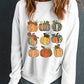 Pumpkin graphic long sleeve sweatshirt on a woman.
