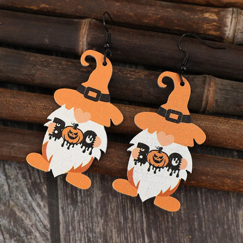 A pair of wooden dwarf pumpkin dangle earrings.
