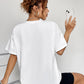 A woman from behind wears a white round neck short sleeve t-shirt.