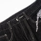 Men's black straight leg jeans with white skeleton embroidery.
