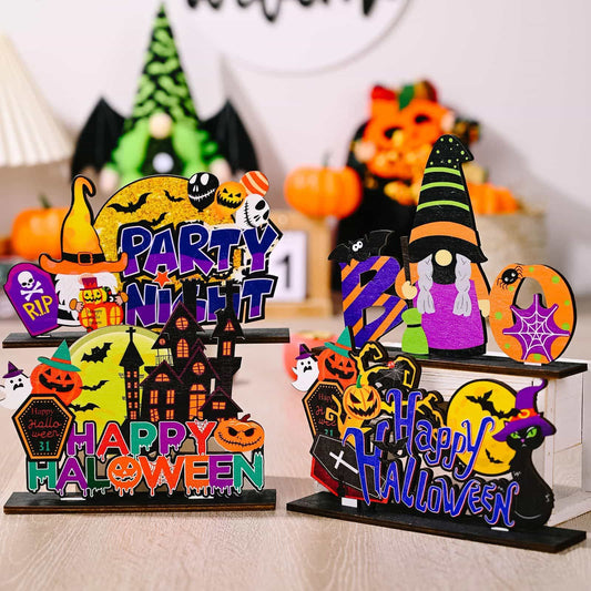 Two assorted Halloween-themed wooden ornaments are displayed on a light wooden surface.