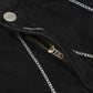 Close-up of black jeans with white chain embroidery and a partially unzipped fly.