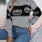 Gray long-sleeve sweater with black pumpkin designs.