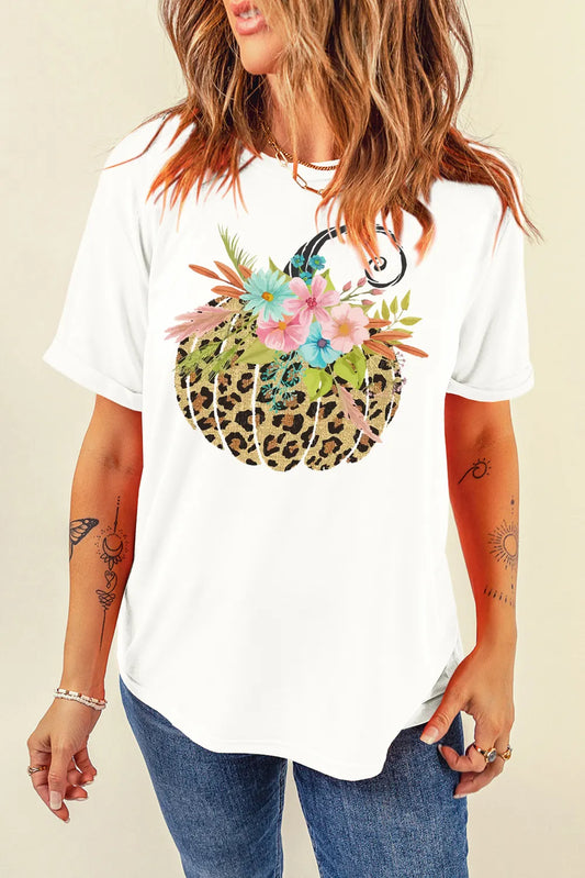 A woman wears a white short-sleeve t-shirt with a leopard print pumpkin graphic.